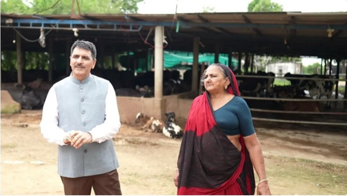 Banas Dairy Chairman Shankar Chaudhary interacts with Navalben Chaudhary at her farm in Banaskantha district of Gujarat